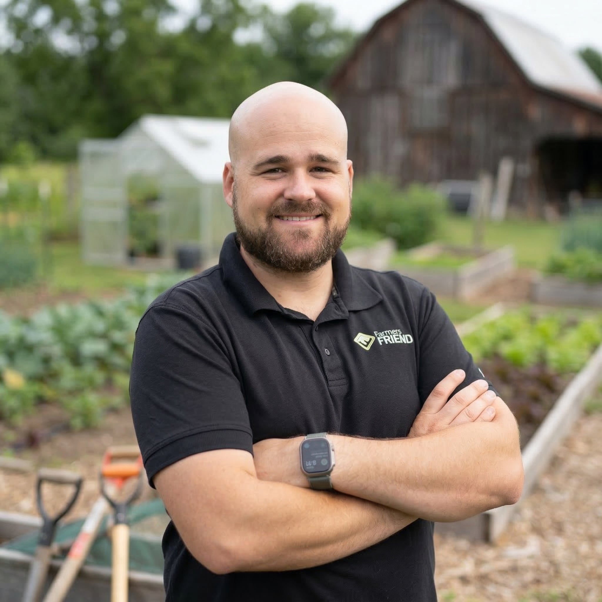 Jonathan, founder of Farmers Friend, standing in front of his market garden and barn